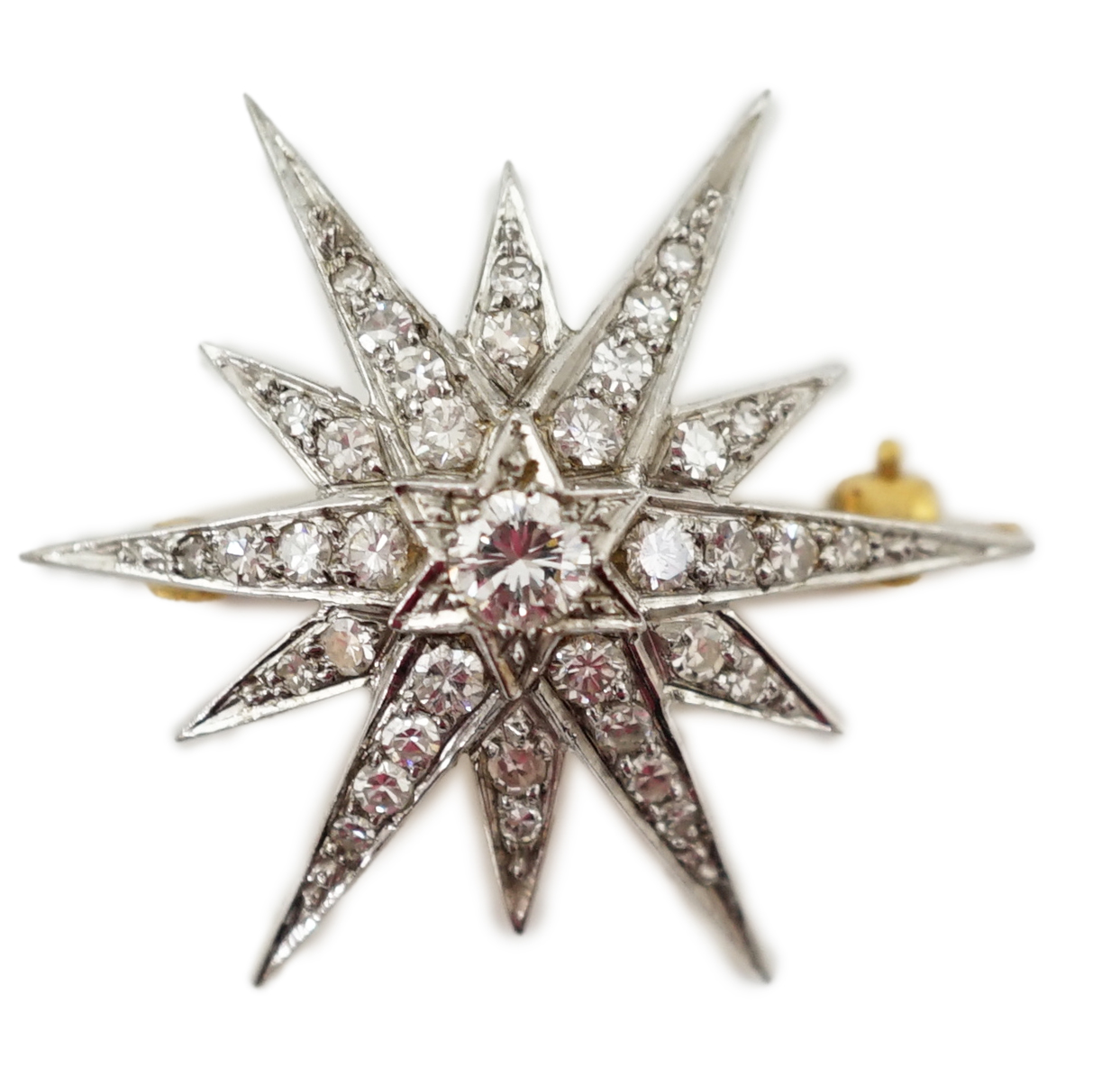 An Edwardian gold and diamond cluster set starburst brooch